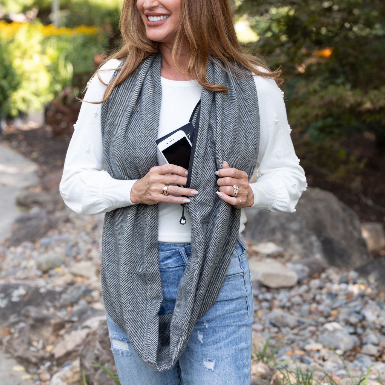 SHOLDIT Infinity Scarf with Pocket™ shown long with phone and passport