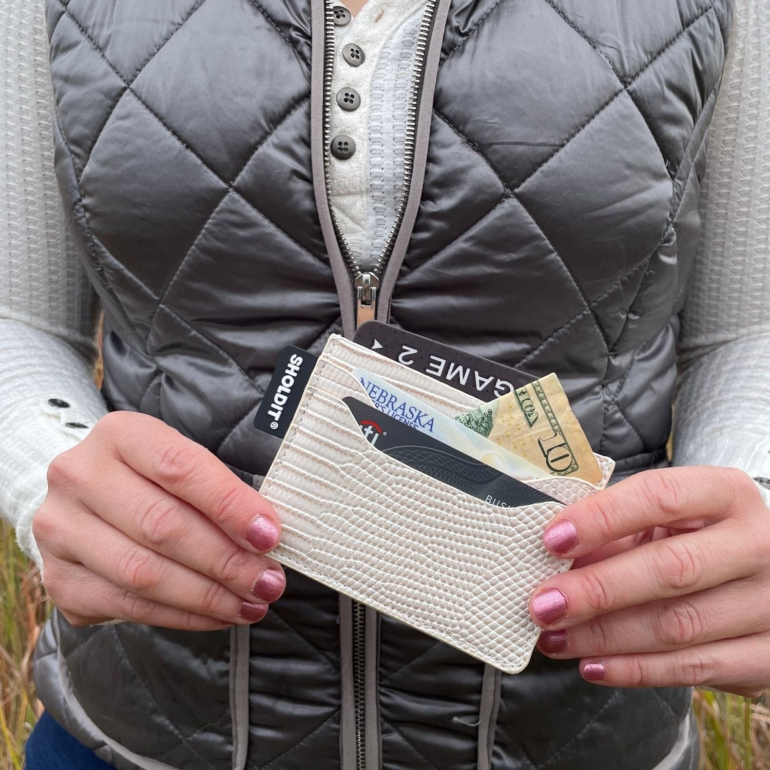 SHOLDIT card holder wallet shown in hands